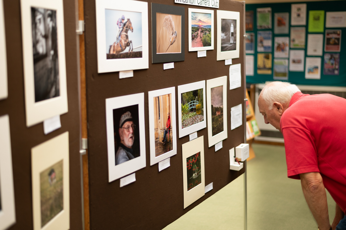 Photo of man looking at Wincanton Library Photo exhibition